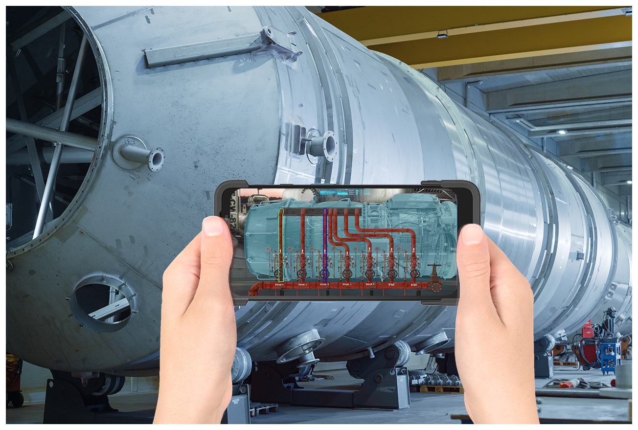 Technik trzyma terminal Unitech PA768 przed zbiornikiem przemysłowym, na ekranie widać nałożony schemat instalacji w rozszerzonej rzeczywistości